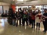 Office Team Celebrates Christmas in Ugly Sweaters