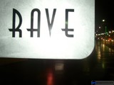 Neon Rave Sign Lights Up City Skyline