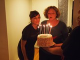Birthday Wishes: Two Women Blowing Out Candles Together