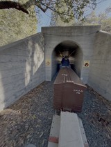 Historic Railway Tunnel with Train Cars