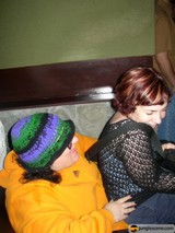 Hat-clad Women on a Cozy Couch