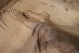 Sculpted Feet in a Cross Room