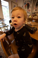 Curious Toddler in Dinosaur Pajamas at Home