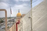 Flag Flying High Above Historic Building