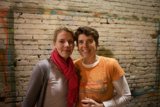 Smiling Women against Brick Wall