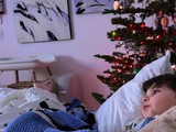 Child Gazing at Christmas Tree on Winter Morning