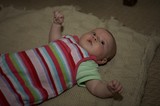 Curious Baby Lying on Knit Blanket Floor