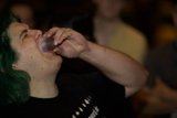 Green-Haired Man Takes a Sip