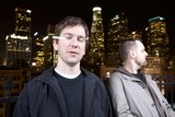 Night Skyline with Two Men standing in Downtown