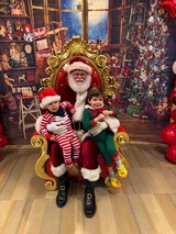 Two Children Visit Santa in His Christmas Workshop