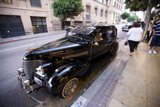 Black Convertible Hot Rod Parked on a Sidewalk