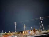 Urban Night Scene with Power Lines and Industrial Buildings