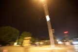 Blurry Street Light Illuminates Night Road