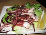 Octopus on a Plate with Lettuce and Lemon