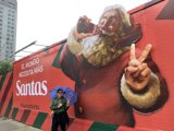 Santa Claus Billboard and the Man with the Umbrella