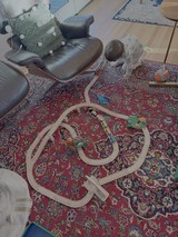 Child Playing with Wooden Train Set at Home