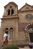 Statue of a Woman Standing in Front of a Church