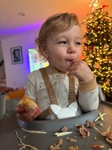 Toddler Enjoying Christmas Dinner at Holiday Table