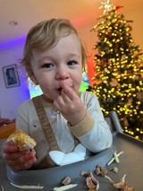 Toddler Enjoying Christmas Dinner at Festive Table