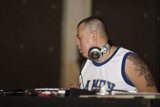 White Tank Top Musician Rocking the Turntable