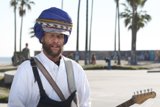 Turbaned Guitarist Amongst Palm Trees