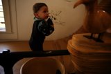 Young Curiosity: A Boy and a Wooden Bird