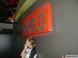 Woman Standing in Front of "World" Sign