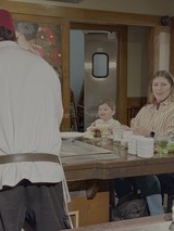 Family Enjoying Sushi at Japanese Restaurant