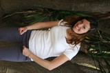 Smiling Woman Posing Between Tropical Trees