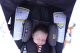 Newborn Baby Sleeping Peacefully in Car Seat
