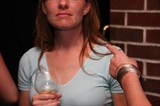 Woman Holding Whiskey Glass at Brick Wall Bar