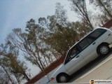 White Car Cruising on Open Road
