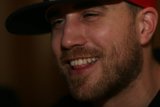 Smiling Bearded Man in Red Hat
