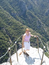 Fearless Adventurer Atop Rocky Summit with Canyon Views
