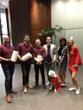 Red-Shirts Posed with their Furry Friend