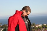 Red Jacket Against the Blue Ocean