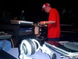Red-Shirted Deejay Spinning the Mix