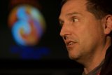 Man Gazing at Mars Lander Log on Screen