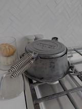 Vintage Cast Iron Waffle Maker on Stovetop