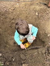 Toddler Exploring and Playing in Muddy Dirt