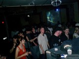Nightclub Party with Man on Screen