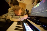Young Child Learning Music Production with Parent
