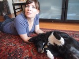 Woman Relaxing on Rug with Black and White Dog