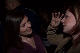 Two Women in Animated Conversation at Nighttime Event