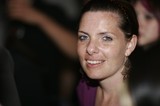 Smiling Woman with Blue Eyes at Evening Event