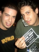 Two men holding up a card with an advertisement