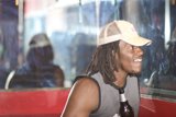 Dreadlocked Man Enjoying a Beer at a Table