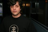 Alan W in Black T-Shirt Standing in Front of Television