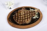 Juicy Steak with Sauteed Onions on a Black Plate