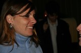 Smiling Woman in Blue Fleece at Evening Event